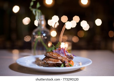 Fine Dining Food Close Up.Mixed Menu Of Grilled Seafood And Beef Served On White Plate With Decoration And Bokeh Background.Fine Dining Culinary Art.