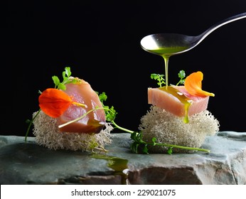 Fine dining, fresh raw ahi tuna sashimi served on sponge with herbs - Powered by Shutterstock