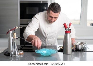 Fine dining restaurant chef preparing delicious plate with sophisticated utensils in commercial kitchen. High quality photo
