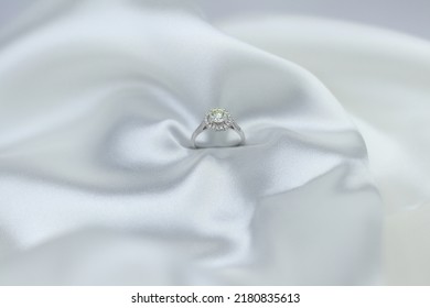 Fine Jewelry As Diamond Ring With Diamond With White Satin Fabric Background. Jewelry Shop Concept