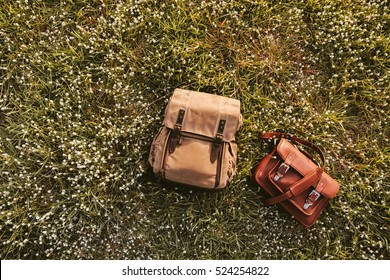 Fine Quality Handmade Leather Messenger Camera Bag And Backpack Flat Lay On Grass