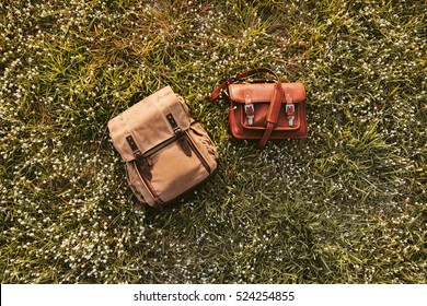 Fine Quality Handmade Leather Messenger Camera Bag And Backpack Flat Lay On Grass