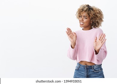 I am fine really, thanks but no. Portrait of awkward intense and displeased african girl receiving disturbing suggestion waving in rejection with hands near body grimacing apologizing for refusal
