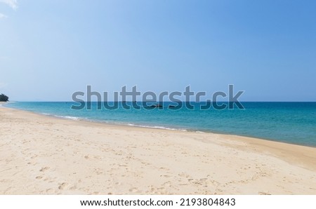 Fine sandy beach with blue sea background, tropical summer beach, tropical island in south of Thailand