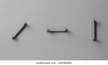 Fine three metal gray hangers on the same color textured wall indoors. Closeup horizontal photo. - Shutterstock ID 1295369401