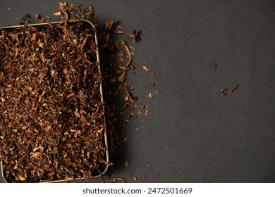 fine tobacco in a gold iron box on a black table