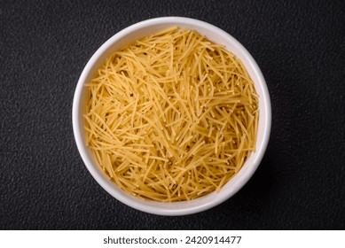 Fine vermicelli paste is yellow in color when raw. Prepare a delicious nutritious side dish - Powered by Shutterstock