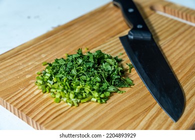 Finely Chopped Coriander Leaves On A Wooden Chopping Board