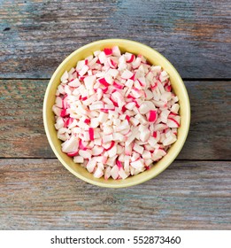 finely chopped crab sticks in a bowl on old wooden table. close-up, top view