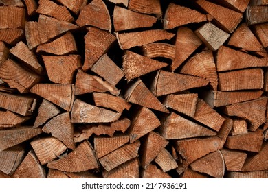 Finely chopped and stacked firewood. Stacks of Firewood. Preparation of firewood for the winter. Firewood background. 