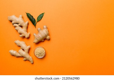 Finely dry Ginger powder in bowl with green leaves isolated on colored background. top view flat lay. - Shutterstock ID 2120562980