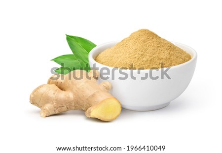 Finely dry Ginger powder in white bowl with fresh rhizome slices and green leaves isolated on white background.