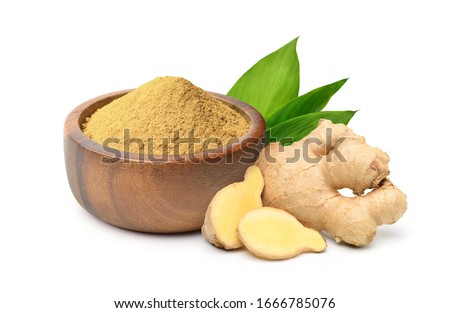 Finely dry Ginger powder in wooden bowl with  rhizome (root) sliced and green leaves isolated on white background.