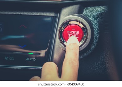 Finger about to touching and press button function start and stop luxury car engine in the automobile on the road trip. Owner and dealership concept