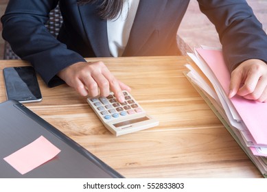 Finger accountant  pressing on calculator in office - Shutterstock ID 552833803