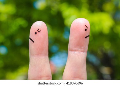 Finger art of couple after an argument looking in different directions.