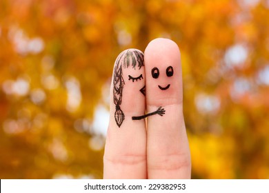 Finger art of a Happy couple. Girl kisses boy on the cheek. 