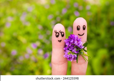 Finger Art Of A Happy Couple.  Man Is Giving Flowers To A Woman. 