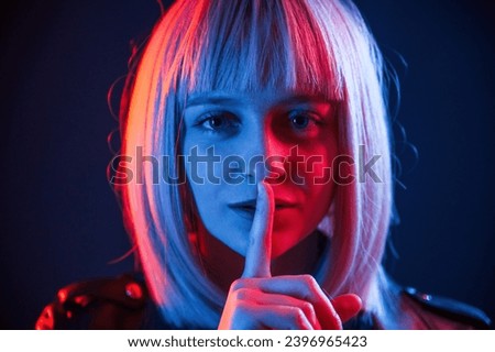 Similar – Young blonde woman asking for silence