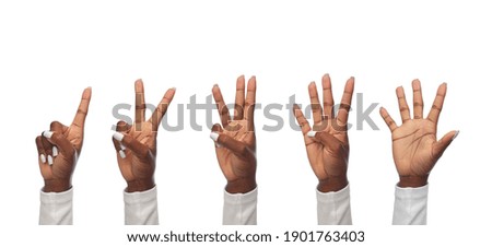 finger count, gesture and people concept - hands of african american women showing fingers on white background
