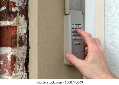 finger entering code on Keypad used on a garage door entrance to a home - security keypad - security code