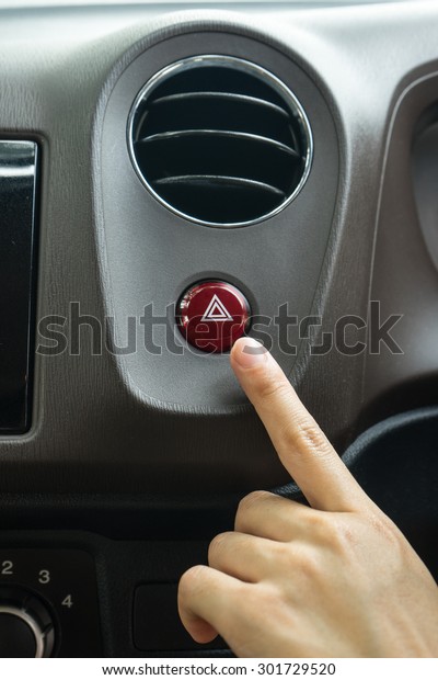 finger hitting car\
emergency light botton