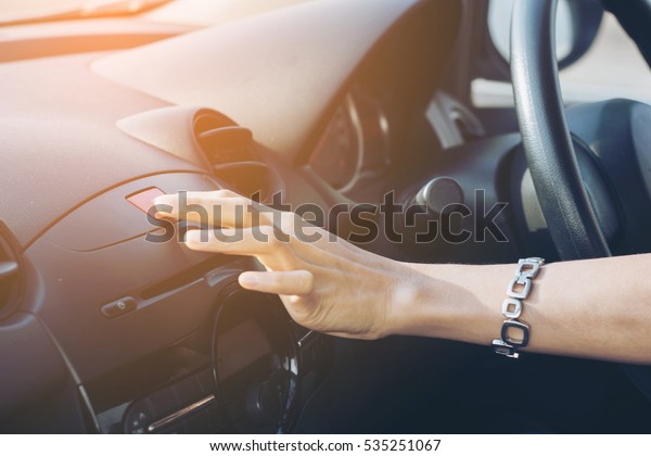 finger hitting car emergency light\
botton, man pressing red triangle car hazard warning\
button