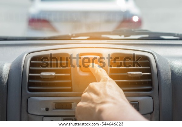 finger hitting car\
emergency light button