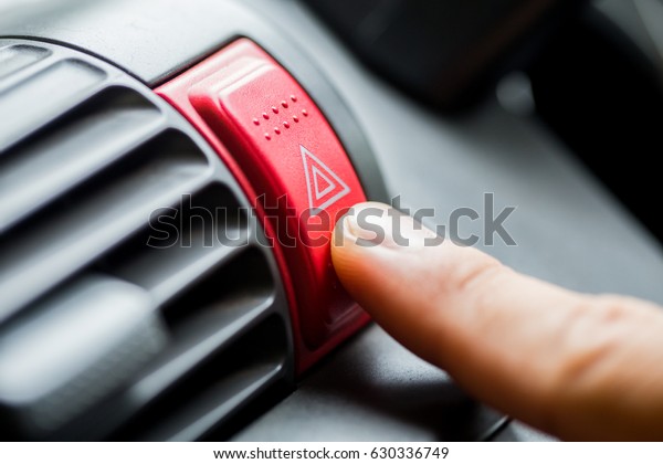 finger hitting car emergency light botton, man\
pressing red triangle car hazard warning button,finger hitting car\
emergency light botton