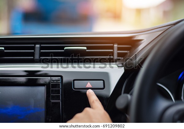 Finger hitting car\
emergency light botton