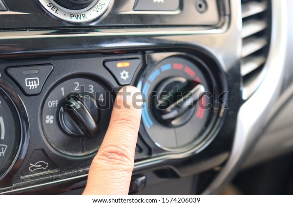 FINGER INDICATING CAR\
AC ON AND OFF BUTTON