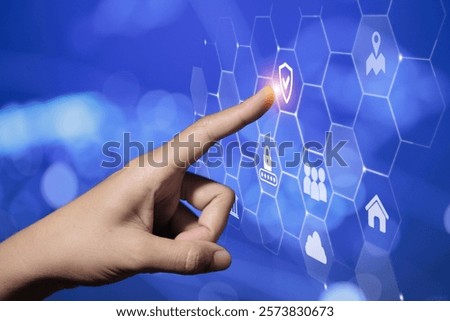 A finger interacting with a hexagonal digital interface displaying security icons, representing advanced technology and secure connections.