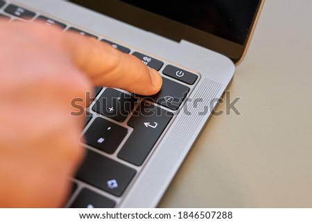Finger on backspace key delete key of notebook laptop