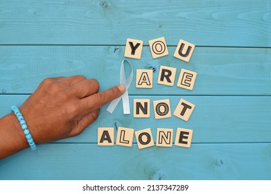 Finger On Blue Ribbon (Prostate Cancer Symbol) Next To You Are Not Alone Tiles