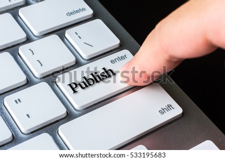 Finger on computer keyboard keys with Publish word