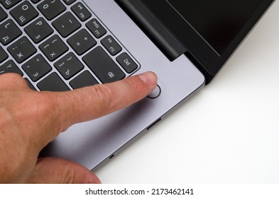 finger on fingerprint sensor on laptop - Shutterstock ID 2173462141