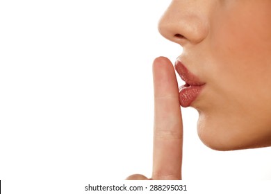 finger on her lips. silence gesture