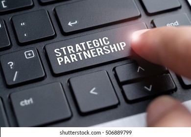Finger on laptop keyboard written Strategic Partnership