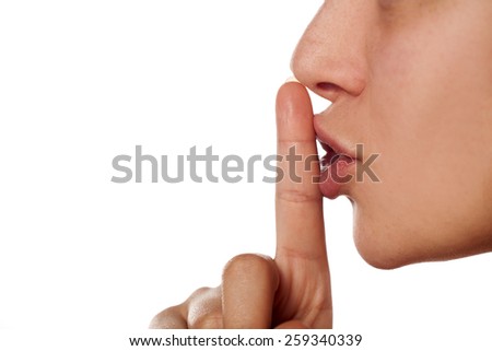 finger on the lips. sign for silence