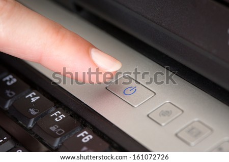 finger over the notebook shutdown button 
