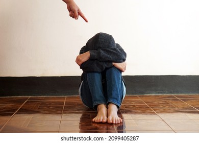 A Finger Point To A Guilty Feeling Boy Sit On The Floor. Concept : Intimidation Or Stick Discipline Strategy To Control Or Punish Kid Behavior That Affect To Mental In Childhood. Psychology.