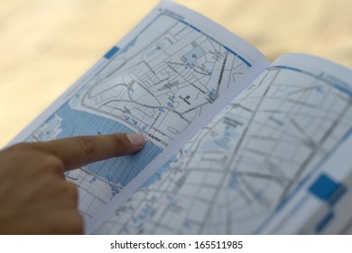 finger pointed on a map