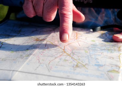 Finger pointing at map 