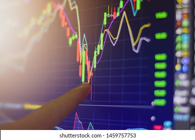 Finger pointing on stock exchange market chart investment trading for take a profit with trading long or short order position on computer monitor screen close up. - Shutterstock ID 1459757753