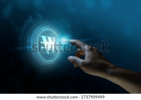 A finger is pointing at a touchscreen or visual display. The value of the won economic concepts, finance, investment, exchange.