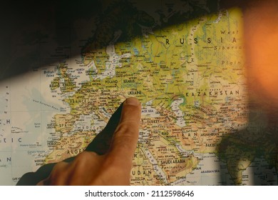 Finger pointing Ukraine on the map. Conflict between Russia and Ukraine - Shutterstock ID 2112598646