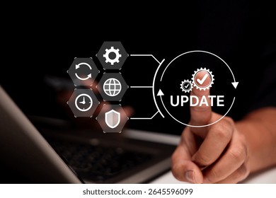 A finger points at a digital interface displaying the word "UPDATE" with gears and icons representing system settings and synchronization.