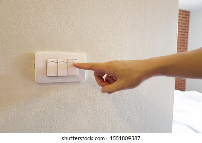 
Finger Press The Bedroom Light Switch On The White Wall