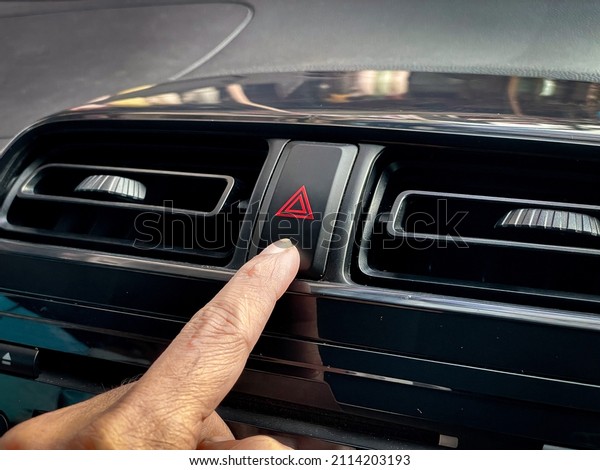 finger to press\
the car emergency light\
button