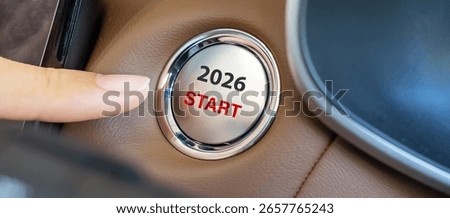 Finger press a car ignition button with 2026 START text inside  automobile. New Year New You, forecast, resolution, motivation, change, goal, vision, innovation and planning concept